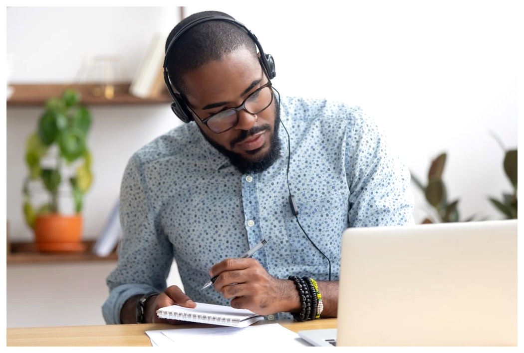 Man studying at computer with headphones