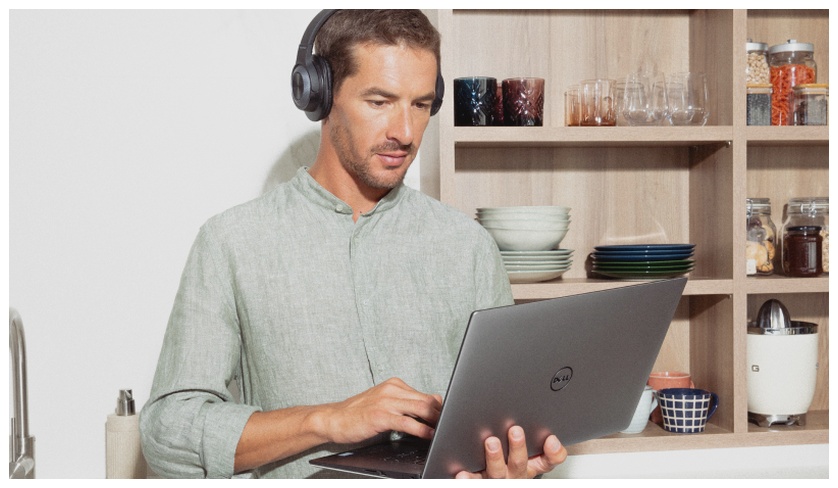 Preply learner standing up with laptop on hands