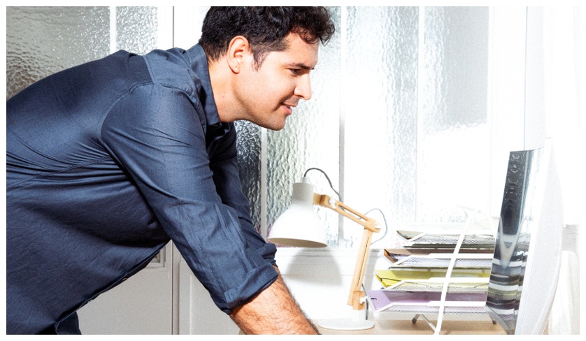 Preply learner leaning over a computer